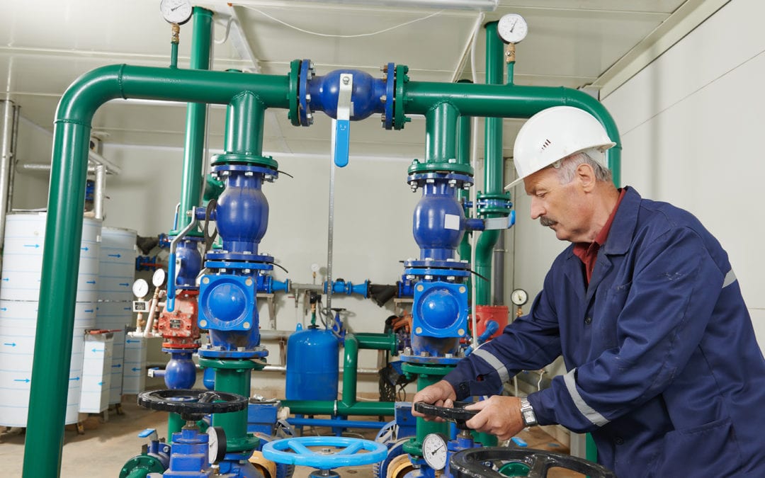 a maintenance worker adjusting a valve