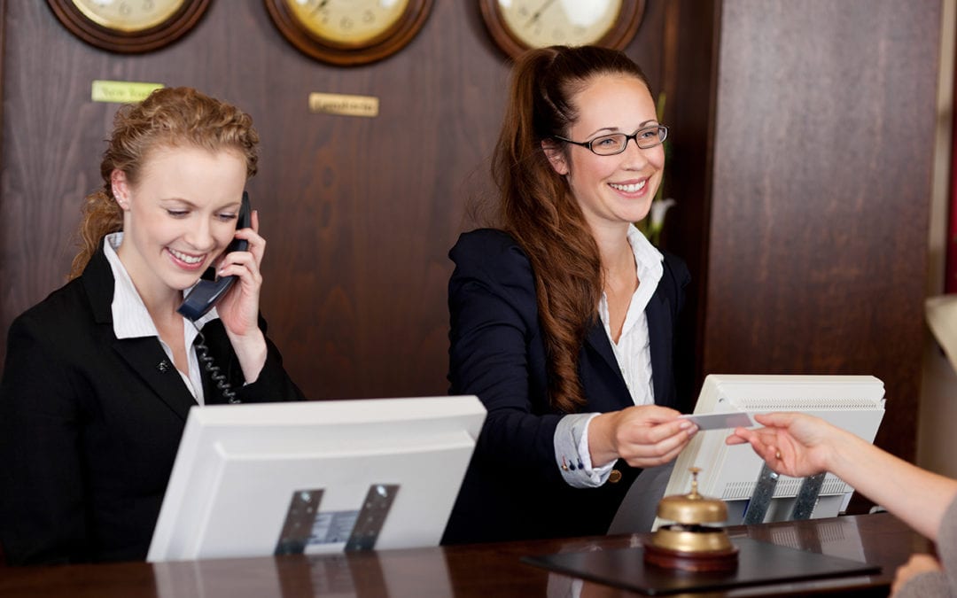 two concierge employees at their desk