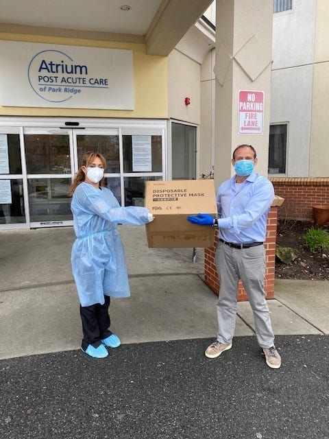 Robert Francis of Planned donating protective masks to Atrium Post Acute Care